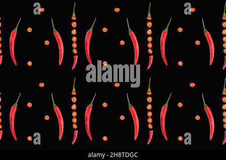 Seamless spice pattern with red chili pepper pods vertically, slices of cut pepper on black background. Healthy eating concept Stock Photo