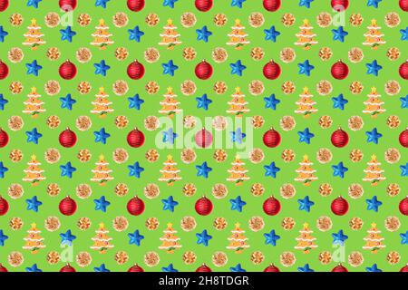 Seamless New Year's pattern from Christmas tree toy in form of spruce tree made of cookies, red balls, blue stars, golden cones on green background. C Stock Photo