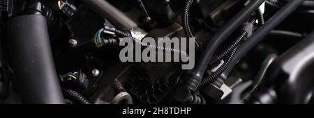 Closeup of electronics and engine under hood of car Stock Photo