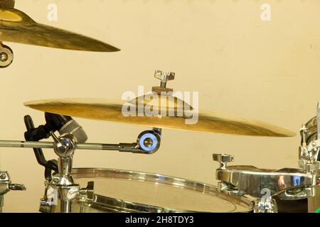 Drum set with microphone in a professional music studio. Musical equipment. Drums of different sizes and drum cymbals. Percussion instruments. Musical Stock Photo