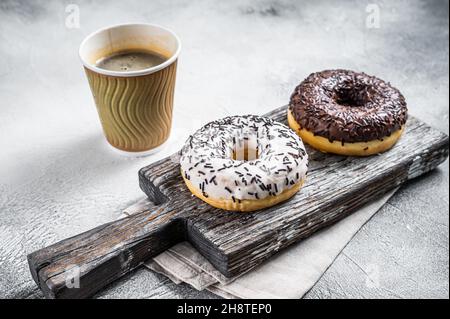 Fresh Chocolate artisan donuts and take away coffee. White background. Top view Stock Photo