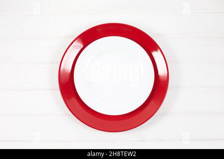 Empty ceramic red and white plates on white wood background. table setting. Happy Valentines day. Stock Photo