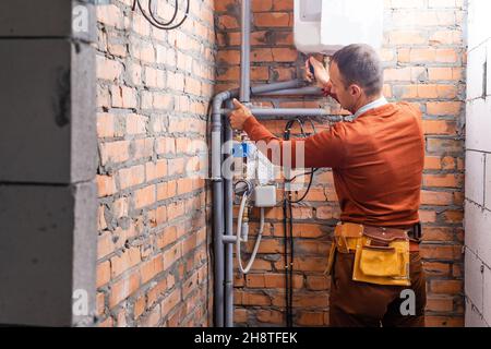 a plumber engineer repairing pipes at work Stock Photo