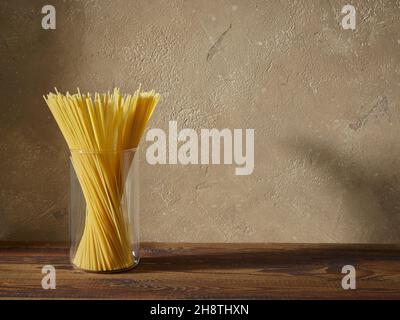 spaghetti pasta on brown kitchen wooden shelf Stock Photo