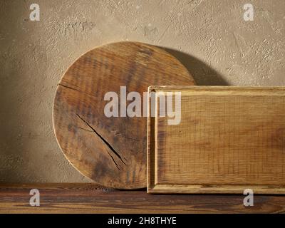 wood cutting boards on brown wooden kitchen shelf Stock Photo