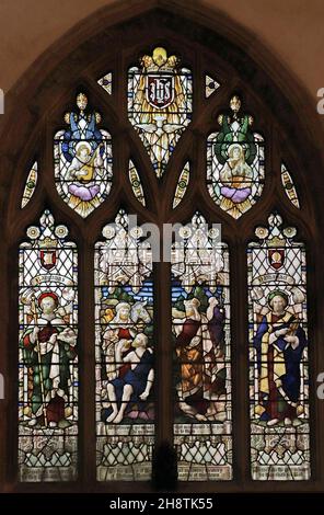 A stained glass window by Robert Newbery depicting The Good Samaritan, St Barnabas & Nathaniel, St Mary's Church, Usk, Monmouthshire Stock Photo