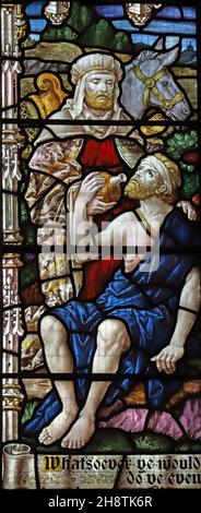 A stained glass window by Robert Newbery depicting The Good Samaritan, St Mary's Church, Usk, Monmouthshire Stock Photo