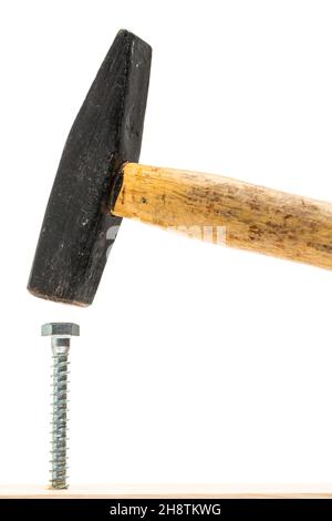 Drive screw in with a hammer - the wrong tool Stock Photo