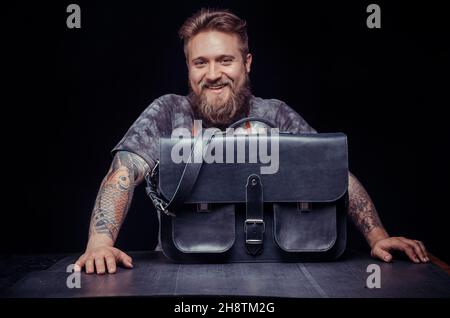 Handicraftsman producing leather goods in the shop Stock Photo