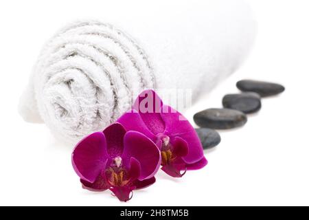 Towel, stones and flowers isolated on white background Stock Photo