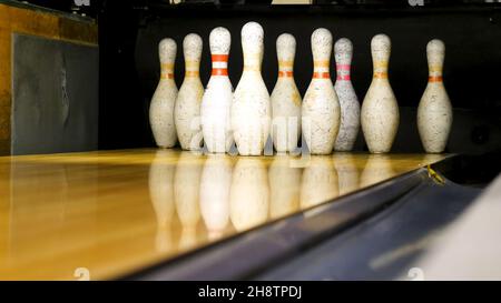 White pins are on the bowling line. Media. Bowling pins are in a row for the game. Stock Photo