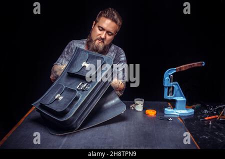 Leather Artist producing leather workpiece in workshop Stock Photo