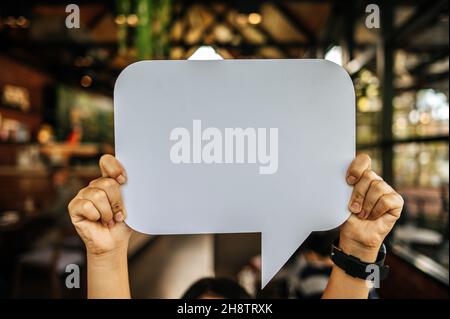 woman holding speech bubble rectangle with conners rounded Stock Photo