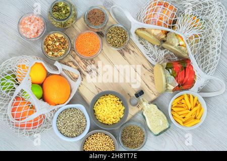 Various farm organic products in glass jars on a white wooden background. Zero waste shopping and sustanable lifestyle concept. Top view, copy space. Stock Photo