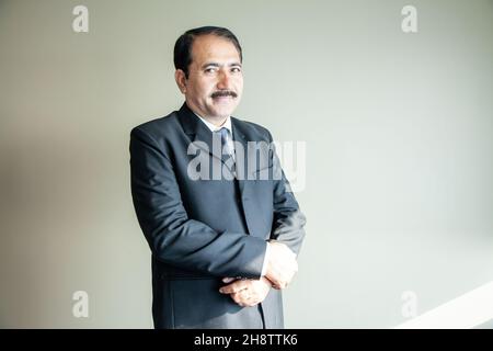 Mature senior company director CEO holding hand portrait Stock Photo