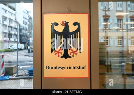 02 December 2021, Baden-Wuerttemberg, Karlsruhe: A sign with the federal eagle and the lettering Federal Supreme Court, taken in front of the Federal Supreme Court (BGH). The Third Criminal Senate is hearing cases on the NSU complex. It is about the review of the conviction of the alleged accomplice André E. In 2018, the Munich Higher Regional Court had sentenced him to two and a half years in prison for supporting a terrorist organisation. Both he and the federal prosecution have appealed against this. E. wants acquittal, the prosecutors had demanded a much higher sentence. Photo: Uli Deck/dp Stock Photo