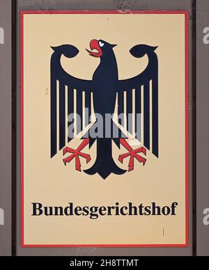 02 December 2021, Baden-Wuerttemberg, Karlsruhe: A sign with the federal eagle and the lettering Federal Supreme Court, taken in front of the Federal Supreme Court (BGH). The Third Criminal Senate is hearing cases on the NSU complex. It is about the review of the conviction of the alleged accomplice André E. In 2018, the Munich Higher Regional Court had sentenced him to two and a half years in prison for supporting a terrorist organisation. Both he and the federal prosecution have appealed against this. E. wants acquittal, the prosecutors had demanded a much higher sentence. Photo: Uli Deck/dp Stock Photo