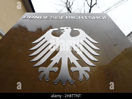 02 December 2021, Baden-Wuerttemberg, Karlsruhe: A sign with the federal eagle and the lettering Federal Supreme Court, taken in front of the Federal Supreme Court (BGH). The Third Criminal Senate is hearing cases on the NSU complex. It is about the review of the conviction of the alleged accomplice André E. In 2018, the Munich Higher Regional Court had sentenced him to two and a half years in prison for supporting a terrorist organisation. Both he and the federal prosecution have appealed against this. E. wants acquittal, the prosecutors had demanded a much higher sentence. Photo: Uli Deck/dp Stock Photo