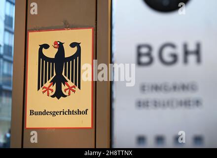 02 December 2021, Baden-Wuerttemberg, Karlsruhe: A sign with the federal eagle and the lettering Federal Supreme Court, taken in front of the Federal Supreme Court (BGH). The Third Criminal Senate is hearing cases on the NSU complex. It is about the review of the conviction of the alleged accomplice André E. In 2018, the Munich Higher Regional Court had sentenced him to two and a half years in prison for supporting a terrorist organisation. Both he and the federal prosecution have appealed against this. E. wants acquittal, the prosecutors had demanded a much higher sentence. Photo: Uli Deck/dp Stock Photo