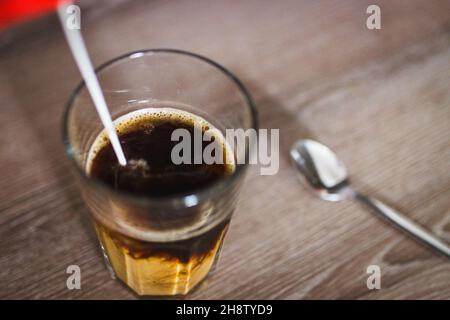 Milk pouring into instant coffee in a glass with spoon, in Prague, Czech Republic, November 9, 2021. (CTK Photo/Martin Macak Gregor) Stock Photo
