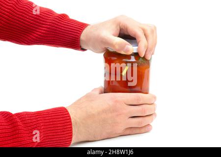 Crop view of male hands opening a jar of pickled tomatoes isolated on white Stock Photo