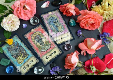 Still life with tarot cards with fantasy skullls, roses and crystals on the pages of the open diary.  Esoteric, gothic and occult background, Hallowee Stock Photo