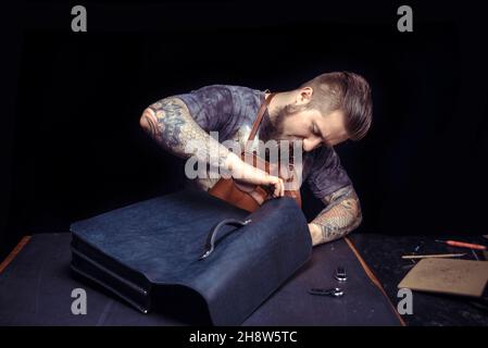 Leather Artist being keen on his buisness Stock Photo