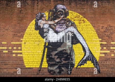 BELFAST, UNITED KINGDOM - Nov 02, 2021: well-known mural in Belfast, the UK depicting a deep-sea diver and mermaid Stock Photo