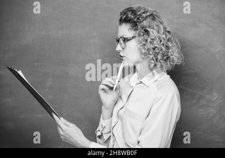 Literature teacher read composition. Read impressing resume. Tutor checking homework. Woman smart lady hold tablet documents. Read personal profile Stock Photo