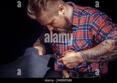 Leather Professional creating new leatherwork Stock Photo