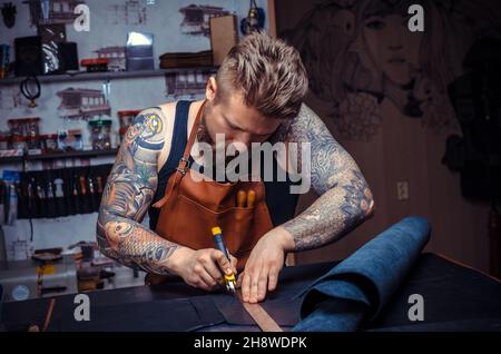 Man working with leather produces leather goods Stock Photo