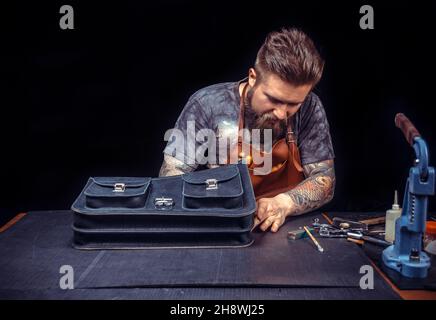 Leather Artist produce a leatherwork at his shop Stock Photo