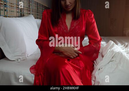 Naked Woman on bed with red satin sheets Stock Photo - Alamy