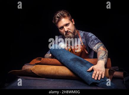 Worker of leather creating a new leather product Stock Photo