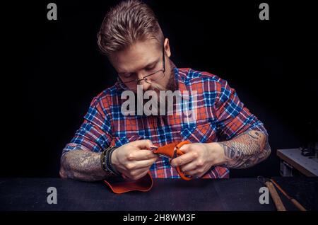 Leather Professional creating new leatherwork Stock Photo