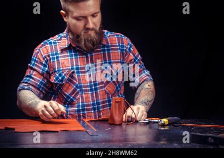 Leather Skinner cutting out leather shapes for a new product Stock Photo