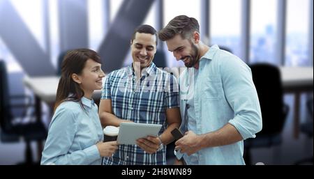 Digital composite image of smiling young business colleagues discussing over digital tablet Stock Photo