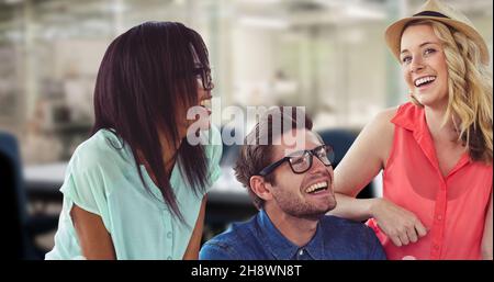 Digital composite image of cheerful young business colleagues enjoying while discussing at office Stock Photo