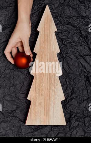 Female hands decorate on the Christmas tree Stock Photo