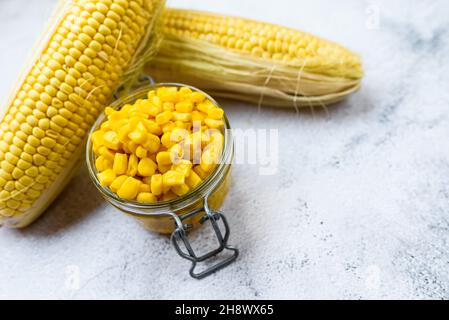 Sweet corn kernels are boiled and packed in cans to preserve their flavor and nutritional properties. Stock Photo
