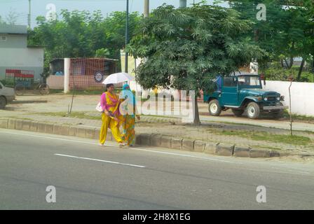 Dhaka, Bangladesh - September 17, 2007: Two unidentified woman in traditional clothing with umbrella Stock Photo