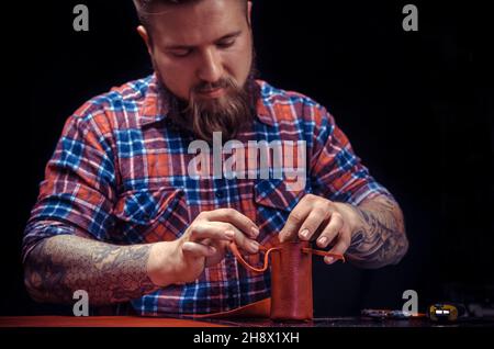 Currier wording with leather goods Stock Photo