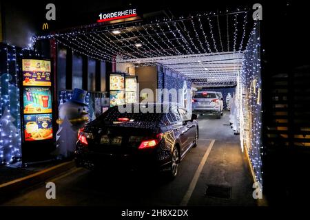 Cars Drive Past Christmas Decorations On A Street In Lagos, Nigeria 