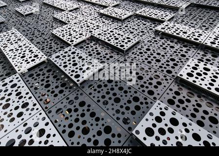 Textured full frame background of gray and white rectangular elements with porous surface placed in rows and making geometric shapes Stock Photo