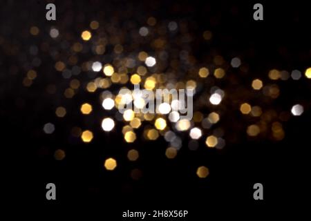 Golden and silver blurred bokeh lights on black background. Glitter sparkle stars for celebrate. Overlay for your design Stock Photo