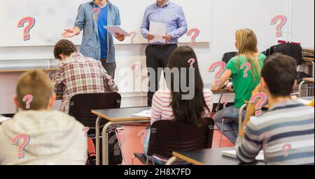 Digital composite of question marks over man giving presentation by professor and students in class Stock Photo