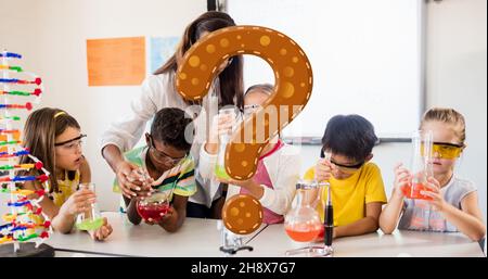 Digital composite of question mark over teacher assisting students in science experiment in class Stock Photo