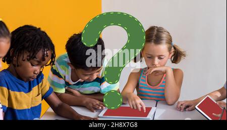 Digital composite of green question mark over elementary students using tablet pc in classroom Stock Photo