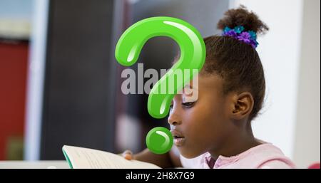 Digital composite of green question mark over confused schoolgirl reading book in classroom Stock Photo