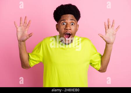 Portrait of attractive funky amazed guy great news sale reaction isolated over pink pastel color background Stock Photo